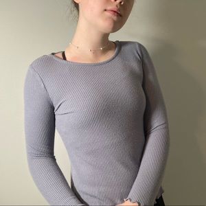 adorable sweater! A grayish blue with a laced lower neck and ruffled cuffs.